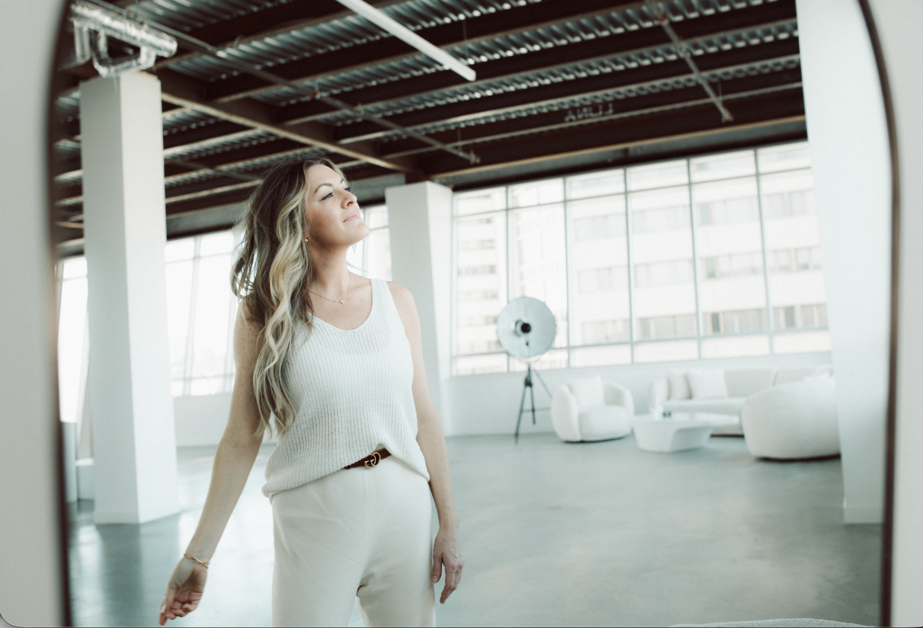 Mackenzie Archibald, RSW, standing in a sunlit loft.